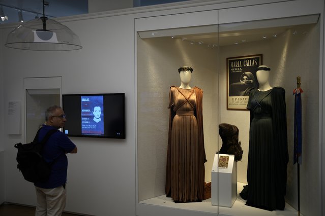 A man looks dresses of Greek Soprano Maria Callas at the newly established Museum, the first dedicated to the legendary opera star, in Athens, Greece, Wednesday, October 25, 2023. The new museum presents, priceless historical artifacts, including photographs and portraits, rare live recordings, and a unique collection of records and personal items as this year is the 100th anniversary of Maria Callas' birth. (Photo by Thanassis Stavrakis/AP Photo)