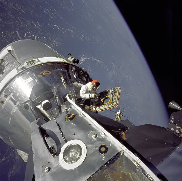 Apollo 9 Command/Service Modules (CSM) nicknamed “Gumdrop” and Lunar Module (LM), nicknamed “Spider” are shown docked together as Command Module pilot David R. Scott stands in the open hatch. Astronaut Russell L. Schweickart, Lunar Module pilot, took this photograph of Scott during his EVA as he stood on the porch outside the Lunar Module. Apollo 9 was an Earth orbital mission designed to test docking procedures between the CSM and LM as well as test fly the Lunar Module in the relative safe confines of Earth orbit. (Photo by NASA)