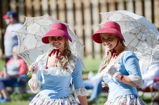 Twins travel down the parade route during the annual Twins Days Festival in Twinsburg, Ohio on August 5, 2017. (Photo by Dustin Franz/AFP Photo)