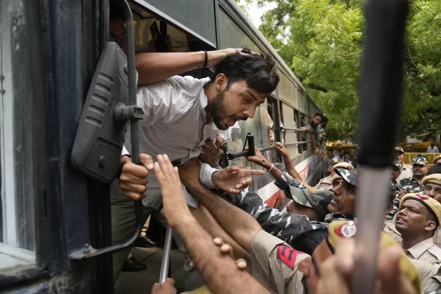 Policemen detain activists from right wing Hindu parties protesting against the Tuesday killing of Kanhaiya Lal, a Hindu man in a suspected religious attack in western Udaipur city in New Delhi, India, Wednesday, June 29, 2022. Police arrested two Muslim men accused of slitting a Hindu tailor’s throat and posting a video of it on social media, representing a dramatic escalation of communal violence in a country split by deep religious polarization. (Photo by Manish Swarup/AP Photo)