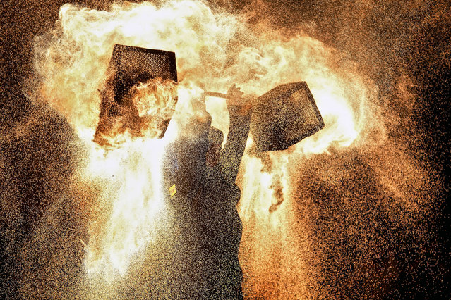 An artist performs a fire kettle show during the Mid-Autumn Festival at a night market in Beijing, Tuesday, September 17, 2024. (Photo by Andy Wong/AP Photo)