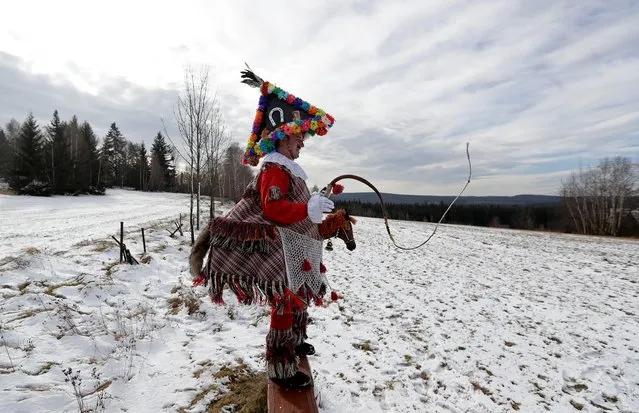 A reveller cracks his whip during a traditional carnival celebrating the departing winter and forthcoming spring in the village of Vortova near the east Bohemian city of Hlinsko, Czech Republic, February 22, 2020. (Photo by David W. Cerny/Reuters)