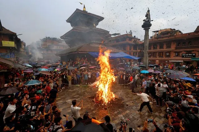 An effigy of demon Ghantakarna is burnt to symbolize the destruction of evil and in belief to drive evil spirits and ghost, during the Ghantakarna festival in Bhaktapur, Nepal on July 26, 2022. (Photo by Navesh Chitrakar/Reuters)