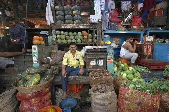 A vegetable vendor sits at a wholesale market in Mumbai, India, Friday, August 5, 2022.India’s central bank on Wednesday raised its key interest rate by 50 basis points to 5.4% in its third such hike since May as it focuses on containing inflation. (Photo by Rajanish Kakade/AP Photo)