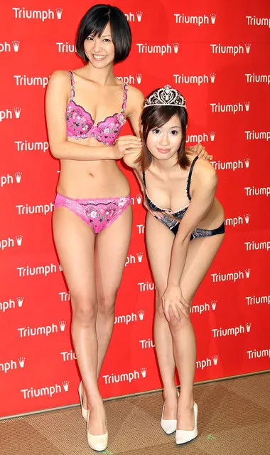 2010 Triumph Image Girl Reiko Aoyama and 2009 Triumph Image Girl Hiromi Nishiuchi pose for photographs during a press conference at Marunouchi Building on October 21, 2009 in Tokyo, Japan.  (Photo by Koichi Kamoshida)