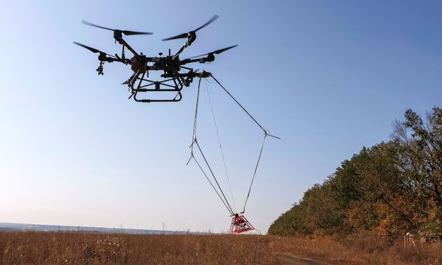 A drone with a metal detector searches for mines near the town of Derhachi in Kharkiv region, Ukraine on October 1, 2023. (Photo by Reuters/Stringer)