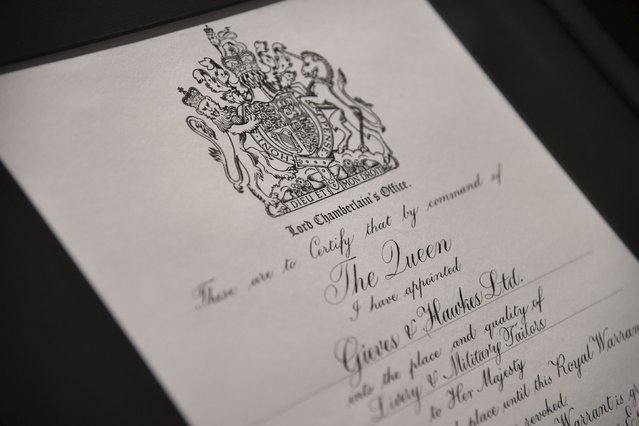A copy of the royal warrant is seen at Gieves and Hawkes in central London, Britain, August 19, 2015. Gieves and Hawkes has contracts with British military forces and has a royal warrant to supply military uniforms and livery for Queen Elizabeth. (Photo by Toby Melville/Reuters)