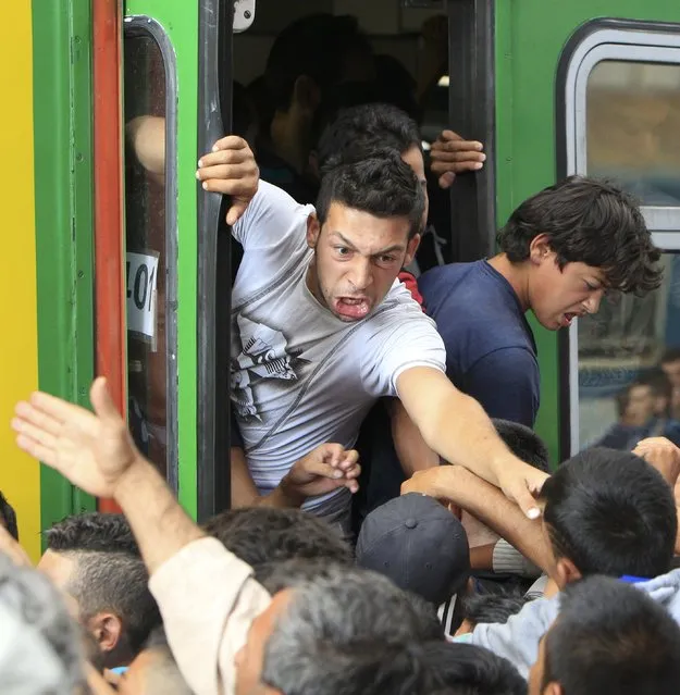 Migrants storm into a train at the Keleti train station in Budapest, Hungary, September 3, 2015 as Hungarian police withdrew from the gates after two days of blocking their entry. (Photo by Bernadett Szabo/Reuters)
