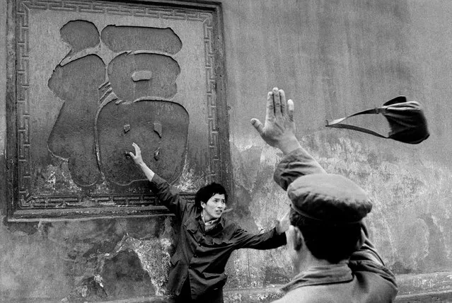 A flying handbag at a monastery in Xindu, China, April 1984. “This photo is an enigma. Even I can’t say for sure what’s happening. I didn’t know what I had taken at the time. It was only afterwards, when I developed the film, that I saw the handbag. It was April 1984 and I was on assignment in China, which was just opening up to foreigners. I had no particular commission, though: I could shoot whatever I wanted. On this day, I was visiting a monastery at Xindu in the Sichuan province. There was a symbol on the wall that meant “happiness”. The place was full of Chinese tourists and the tradition was to stand 20 metres from the sign, then walk towards it with eyes closed and try to touch the centre of the four raised points”. (Photo by Guy Le Querrec/Magnum Photos)