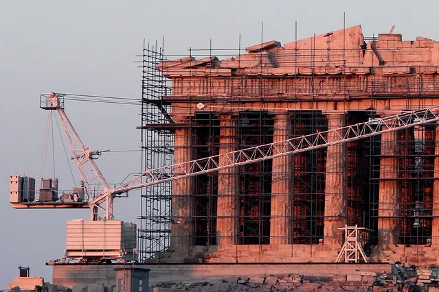 This photo taken on August 4, 2016 shows restoration work at the ancient temple of the Parthenon, atop the Acropolis hill in Athens, on August 4, 2016. Restoration work on Athens' Acropolis is set to shift to the west side of the Parthenon under a 40-year-long effort to restore the ancient archaeological monument, officials said August 4. (Photo by Angelos Tzortzinis/AFP Photo)