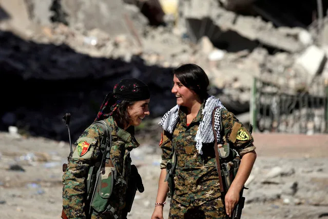 Female fighters from Syrian Democratic Forces (SDF) react in Raqqa, Syria, October 16, 2017. (Photo by Rodi Said/Reuters)