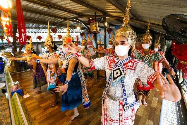 Thai dancers perform while wearing traditional dresses and face masks as a preventive measure at the Temple during the Coronavirus (COVID-19) crisis. Thai government announced that some businesses such as barber shops, outdoor markets, restaurants and golf courses will reopen from May 3, 2020 after a number of new cases of coronavirus slow down. Thailand's Health Ministry recorded a total of 2,988 infections, 54 deaths and 2,747 recovered since the beginning of the outbreak. (Photo by Chaiwat Subprasom/SOPA Images/LightRocket via Getty Images)