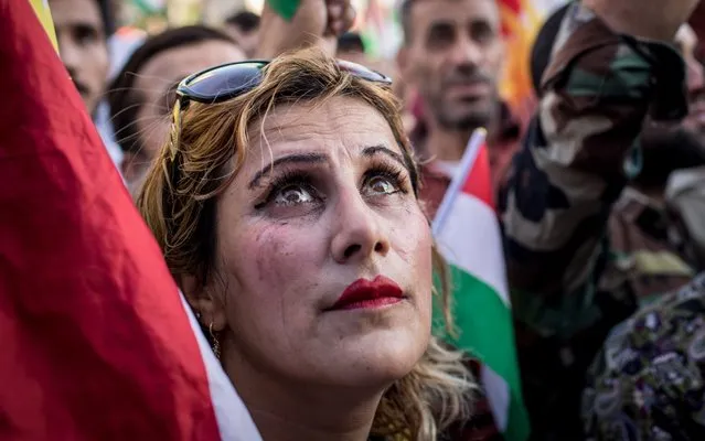 A woman watches on during a protest outside the US Consulate on October 21, 2017 in Erbil, Iraq. The demonstration was held to protest against the escalating crisis with Baghdad and to call on the international community for assistance. (Photo by Chris McGrath/Getty Images)