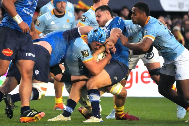 Perpignan's Argentinian number eight Joaquin Oviedo is tackled during the French Top14 rugby union match between USA Perpignan and Castres Olympique at the Aime-Giral stadium in Perpignan, south-western France on February 15, 2025. (Photo by Idriss Bigou-Gilles/AFP Photo)