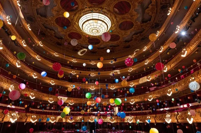 This photograph taken in Barcelona on October 11, 2022 shows the Liceu Grand Theatre filled with balloons as part of an art installation by Brazilian artist Flavia Junqueira. -(Photo by Josep Lago/AFP Photo via Getty Images)