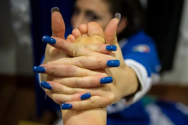 A competitor streches before participating at the World Pole Dancing Championship 2012 held at the Volkshaus on November 10, 2012 in Zurich, Switzerland. The public's perception of pole dancing has recently changed to become a popular sport combining physical strength, technique and choreography.  (Photo by Harold Cunningham)