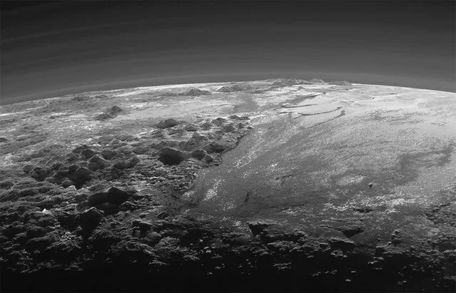 A close-up view of the rugged, icy mountains and flat ice plains on Pluto is seen in an image from NASA's New Horizons spacecraft taken July 14, 2015 and released September 17, 2015. The expanse of the informally named icy plain Sputnik Planum (R) is flanked to the west (L) by rugged mountains up to 11,000 feet (3,500 meters) high. The image was taken from a distance of 11,000 miles (18,000 kilometers) to Pluto. (Photo by Reuters/NASA/JHUAPL/SwRI)