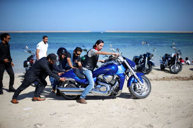 Members of a Tripoli bikers’ group ride their motorbikes at the beach in Libya on November 21, 2017. (Photo by Ahmed Jadallah/Reuters)