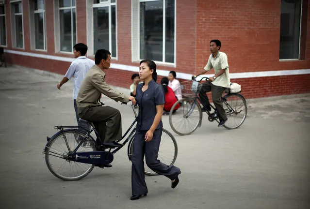 A woman walks in central Rason city, northeast of Pyongyang, August 29, 2011. (Photo by Carlos Barria/Reuters)