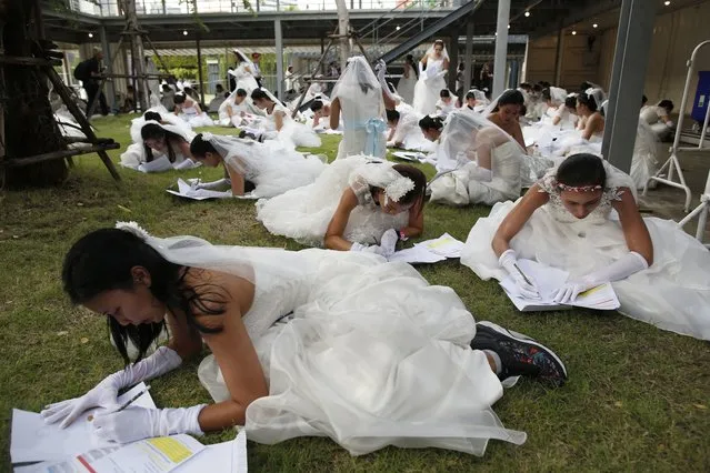 Thai brides-to-be do the maths task in the “Running of the Brides” event in Bangkok, Thailand, 02 December 2017. (Photo by Rungroj Yongrit/EPA/EFE/Rex Features/Shutterstock)