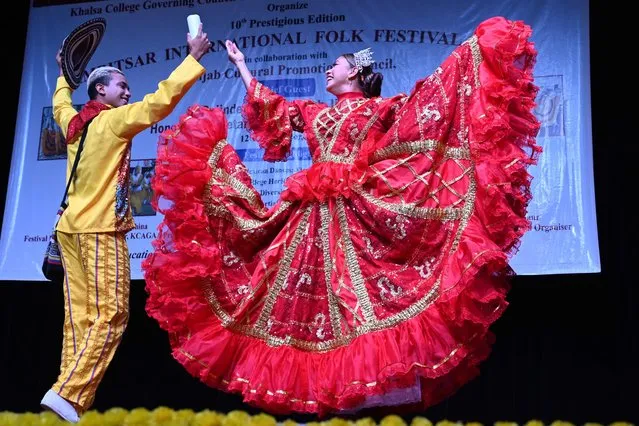 Colombian artists perform a folk dance during Amritsar International Folk Festival at Khalsa college for women in Amritsar on November 12, 2022. (Photo by Narinder Nanu/AFP Photo)