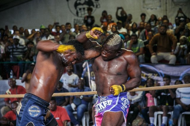Fighters compete during the “Morengy Iarivo” sporting event, a morengy competition organized for the first time in Antananarivo, on April 6, 2025. Barefoot in the dust, their hands wrapped in thin fabric, a handful of athletes practised moraingy, a traditional Madagascan martial art, ahead of a fight in Antananarivo stadium. The competition on Sunday in the capital of the Indian Ocean island is aimed at promoting the age-old combat sport. Moraingy dates back to the 17th century. It originated on the west coast of Madagascar, where it was practised as training for war and as an initiation rite marking the passage to adulthood. It spread as people migrated and is mainly practised today in the north and northwest of the country. (Photo by Rijasolo/AFP Photo)