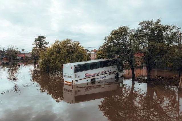 A bus is seen in a flooded area in Lenasia, South Africa on December 10, 2022, following heavy rains. (Photo by Marco Longari/AFP Photo)