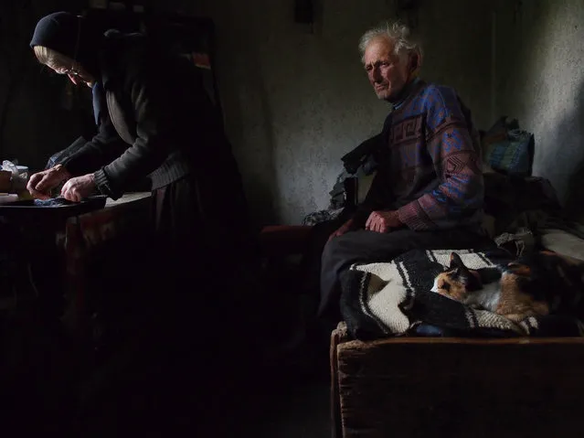 “Waiting”. He was waiting on the bed, lost in thoughts, while his wife was preparing the bread to be blessed for the orthodox Eucharist. Photo location: Village of Sarbi, Maramure, Romania. (Photo and caption by Roberto Fiore/National Geographic Photo Contest)