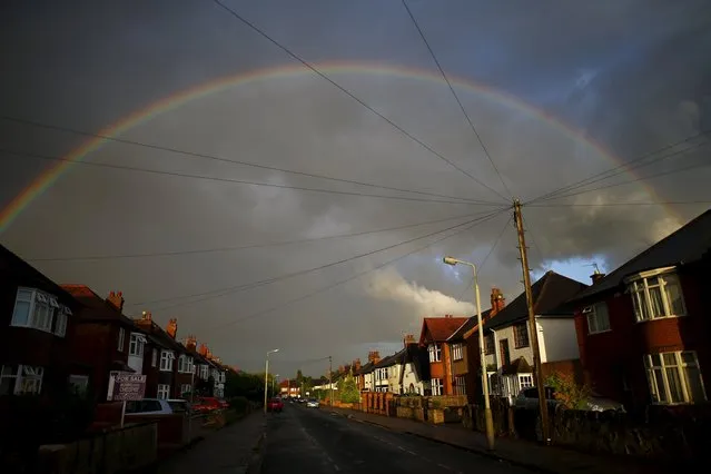 A rainbow arcs over a residential street in Loughborough, Britain July 5, 2015. (Photo by Darren Staples/Reuters)