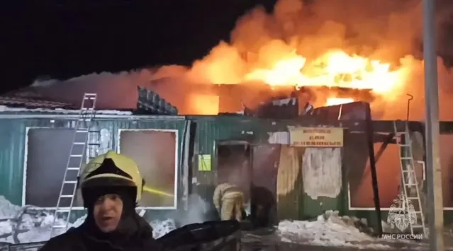 In this handout photo released by the Russian Emergency Ministry Press Service, firefighters try to extinguish a fire at a nursing home in the Siberian city of Kemerovo, Russia, Saturday, December 24, 2022. Russia's emergencies ministry said Saturday that 20 people were killed in a fire at a nursing home in the Siberian city of Kemerovo. The fire broke out before dawn in the two-story wooden building in the city 3,000 kilometers (1,900 miles) east of Moscow. (Photo by Russian Emergency Ministry Press Service via AP Photo)