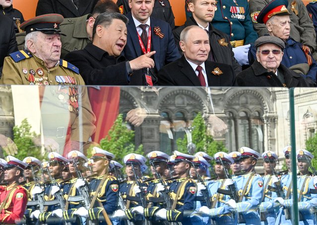 Russian President Vladimir Putin and his Chinese counterpart Xi Jinping attend a military parade on Victory Day, marking the 80th anniversary of the victory over Nazi Germany in World War Two, in Red Square in central Moscow, Russia, on May 9, 2025. (Photo by Sergei Bobylyov/Host agency RIA Novosti/Handout via Reuters)