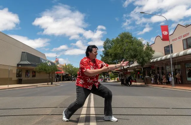 Elvis Tribute Artist, Sheryl Scharkie, also known as ShElvis, strikes a pose in the main street at the Parkes Elvis Festival in Parkes, Australia on January 6, 2023. (Photo by Cordelia Hsu/Reuters)