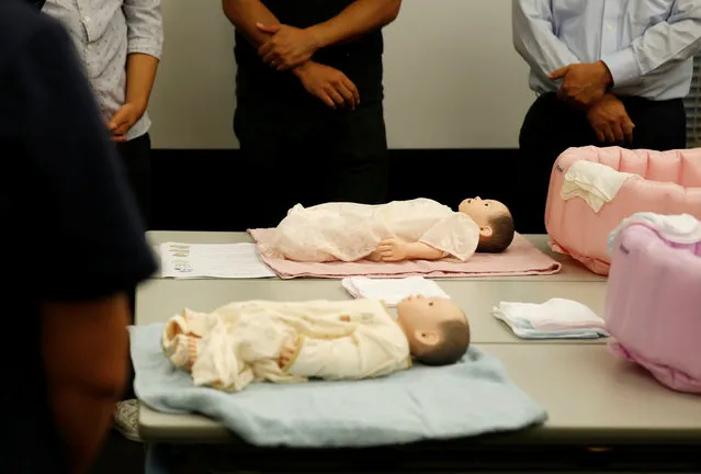 Participants take part in an “Ikumen” course, or child-rearing course for men, organized by Osaka-based company Ikumen University, in Tokyo, Japan September 18, 2016. (Photo by Issei Kato/Reuters)