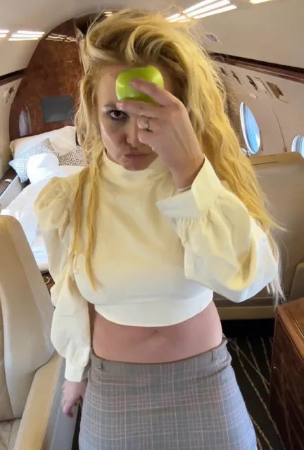 American singer Britney Spears in the second decade of January 2023 poses with an apple on a private plane. (Photo by britneyspears/Instagram)