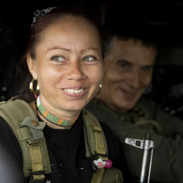 A rebel of the Revolutionary Armed Forces of Colombia, FARC, sits inside a pick-up upon her arrival to Yari Plains, southern Colombia, Sunday, September 25, 2016. President Juan Manuel Santos and FARC leader Rodrigo Londono, alias Timochenko, are expected to sign a peace accord to end more than five decades of conflict Sept. 26 in the Caribbean city of Cartagena. (Photo by Ricardo Mazalan/AP Photo)
