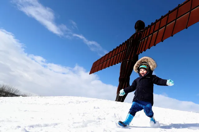 A boy plays in the snow next to the Angel of the North statue near Gateshead, Britain on February 27, 2018. (Photo by Scott Heppell/Reuters)
