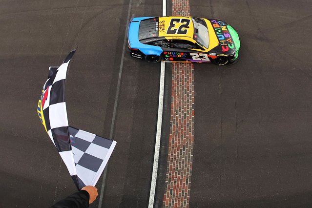 NASCAR driver Bubba Wallace takes the checkered flag as he wins the Brickyard 400 at the Indianapolis Motor Speedway on Sunday, July 27, 2025. Wallace is the first Black driver to win a major race at the iconic track. (Photo by Jonathan Bachman/Getty Images)