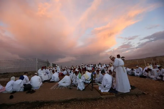 Samaritans pray after they arrived from their village during a Sukkot sunrise service atop Mount Gerizim, above the city of Nablus in the northern West Bank, early 27 October 2015. The Samaritan religion is descended from the ancient Israelite tribes of Menashe and Efraim, and the community numbers today less than 780 people, half of which live on Mount Grizim in the West Bank and the other half in Holon, next to Tel Aviv.  (Photo by Alaa Badarneh/EPA)