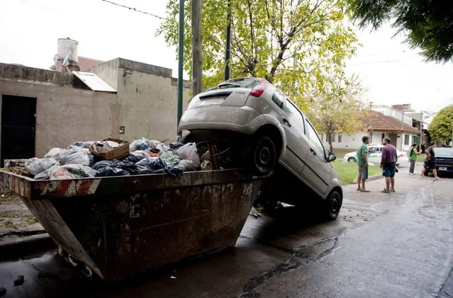 A car lies over a garbage container after heavy rains flooded a large part of the city, in La Plata April 3, 2013. At least 46 people were killed in Argentina on Wednesday after a torrential downpour battered the eastern city of La Plata and forced some 2,200 people to flee their homes in search of dry ground. (Photo by Reuters/Stringer)