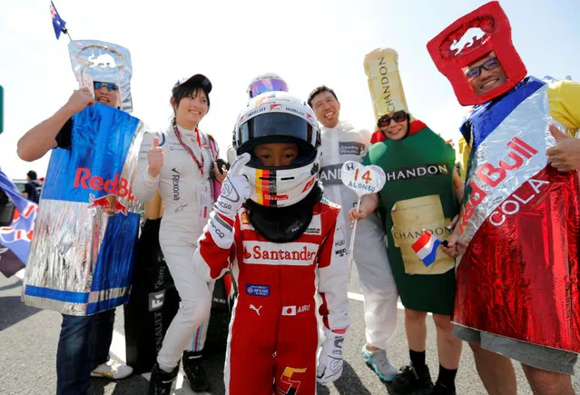 Formula One, Japanese Grand Prix, Suzuka Circuit, Japan on October 6, 2016. A boy dressed as Ferrari's Sebastian Vettel of Germany, poses with fans. (Photo by Toru Hanai/Reuters)