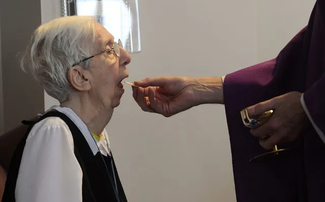 Sister Mary Annette Leonard receives the Eucharist during services at Our Lady of Rickenbach health care facility that is part of the Benedictine Sisters of Perpetual Adoration monastery in Clyde Missouri December 18, 2014. (Photo by Dave Kaup/Reuters)