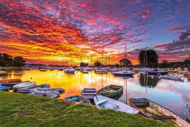 A blazing sunrise lights up boats and yachts moored on the River Stour in Christchurch, Dorset, United Kingdom on October 2, 2022. (Photo by South West News Service)