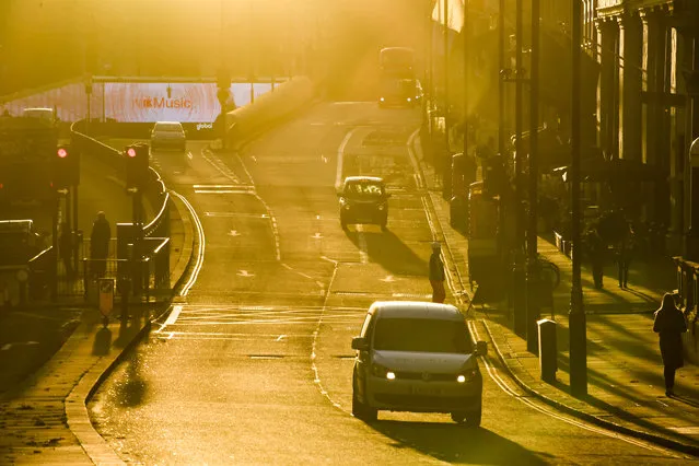 Moderate traffic as the sun sets on Piccadilly, in London, Tuesday, November 24, 2020. Haircuts, shopping trips and visits to the pub will be back on the agenda for millions of people when a four-week lockdown in England comes to an end next week, British Prime Minister Boris Johnson said Monday. (Photo by Alberto Pezzali/AP Photo)