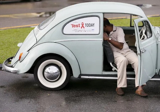 A man sits inside his Volkswagen beetle car as he prepares it for a "World AIDS Day 2015" rally organized by Sri Lanka's UNAIDS in Colombo November 28, 2015. The event is held to commemorate the annual World AIDS Day on December 1. (Photo by Dinuka Liyanawatte/Reuters)