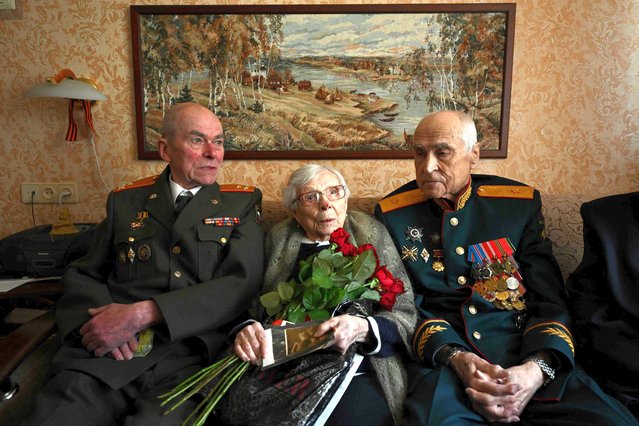 World War Two veteran, anti-aircraft gunner Valentina Goryacheva, 99, is congratulated by members of a local veterans council upon the upcoming Victory Day in Moscow, on May 2, 2023. Cheerful Moscow veterans dance, share toasts with comrades and sing patriotic songs at events leading up to Victory Day. On May 9, Russia will celebrate the 78th anniversary of the Soviet victory against the Nazis in 1945. The last heroes on the Great Patriotic War remain strong and optimistic, proudly looking back at their lives and personal feats. (Photo by Natalia Kolesnikova/AFP Photo)
