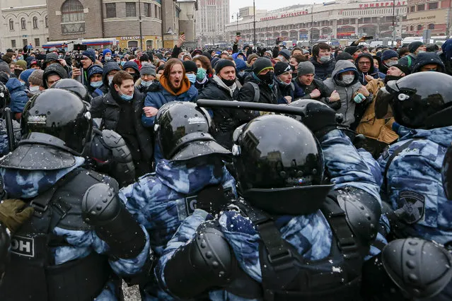 People clash with police during a protest against the jailing of opposition leader Alexei Navalny in Moscow, Russia, Sunday, January 31, 2021. Thousands of people took to the streets Sunday across Russia to demand the release of jailed opposition leader Alexei Navalny, keeping up the wave of nationwide protests that have rattled the Kremlin. Hundreds were detained by police. (Photo by Alexander Zemlianichenko/AP Photo)