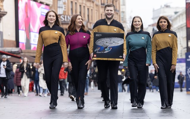 Actor, L-R - Nina Dontu, Rosie Farnell, Martins Strals, Cassandra Baratto and Jaasvi Shah, dressed as a Starfleet crew member from Star Trek, interacts with customers at the launch event for the new LEGO Icons Star Trek: U.S.S. Enterprise set at the LEGO Store Leicester Square, London on Friday, November 28, 2025. (Photo by Matt Alexander/PA Media Assignments)