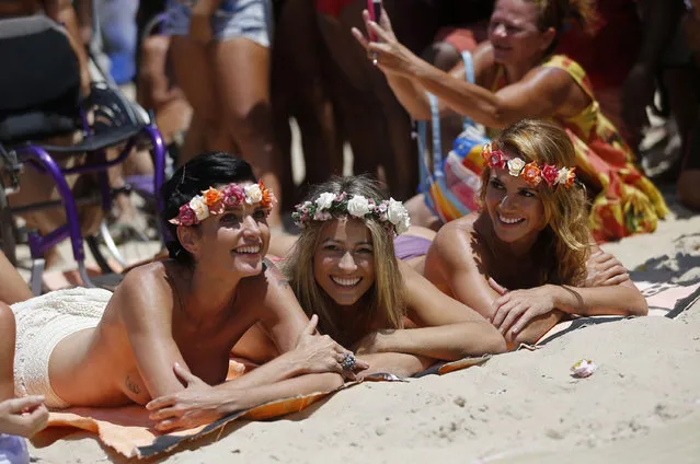 Film producer Ana Paula, left, disability rights advocate Natache, center, and contemporary dancer Karla Klemente join a demonstration on Ipanema beach in support of the rights of women to go topless on beaches nationwide, in Rio de Janeiro, Brazil, Tuesday, January 20, 2015. Under Brazil's penal code which dates back to the 1940's. (Photo by Silvia Izquierdo/AP Photo)