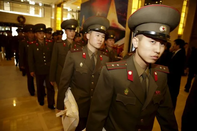 North Korean men and women in military uniforms arrive at a hotel in central Beijing, China, December 11, 2015. (Photo by Reuters/Stringer)