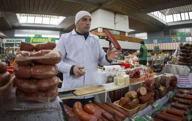 A vendor juggles a sausage at the Green Bazaar in Almaty January 23, 2015. (Photo by Shamil Zhumatov/Reuters)